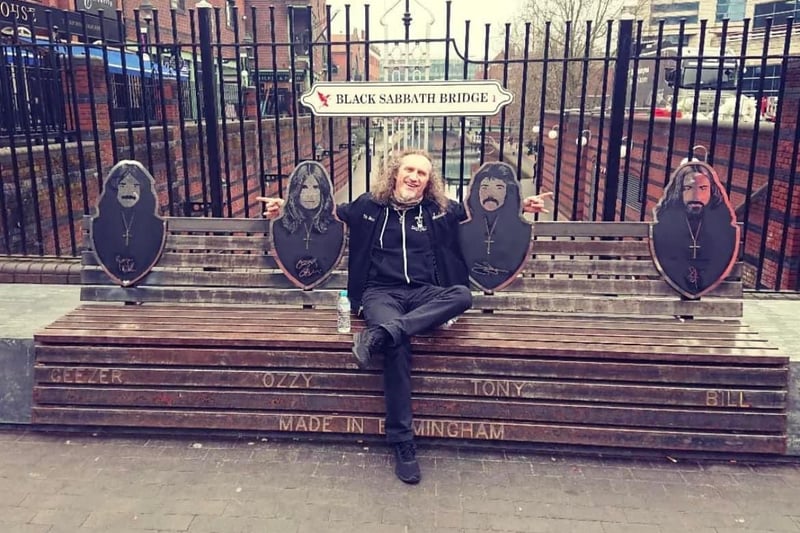 Marek proudly puts his arms around Ozzy Osbourne and Tony Iommi tribute on the Black Sabbath Bench
