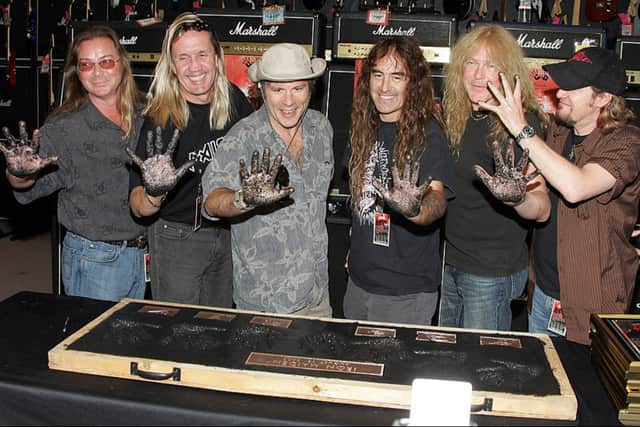 Rock band Iron Maiden members (L-R) Dave Murray, Nicko McBrain, Bruce Dickinson, Steve Harris, Janick Gers and Adrian Smith pose for a photograph as they are inducted Into Hollywood’s Rock Walk. (Photo by Frazer Harrison/Getty Images)