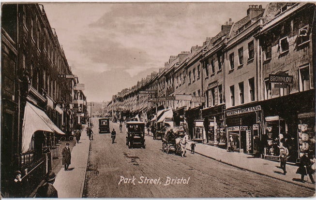 This image was taken looking up Park Street and predates the now-iconic Wills Tower which would be built in 1925. On the right hand side you can see businesses such as John J Brownlow, costumier, dress and mantle maker.