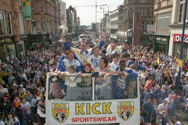The league champions ride an open top bus down Briggate.