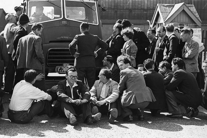 Police move in to clear striking workers away from blocking the entry of a lorry to the Austin factory in Longbridge on 27th July 1956. Birmingham. Women workers joined the men on the sit-down protest.  