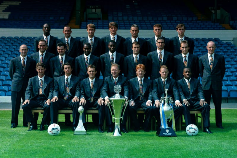 The 92/93 squad show off their latest achievements while posing in front of the West Stand.