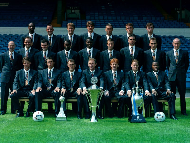 The 92/93 squad show off their latest achievements while posing in front of the West Stand.