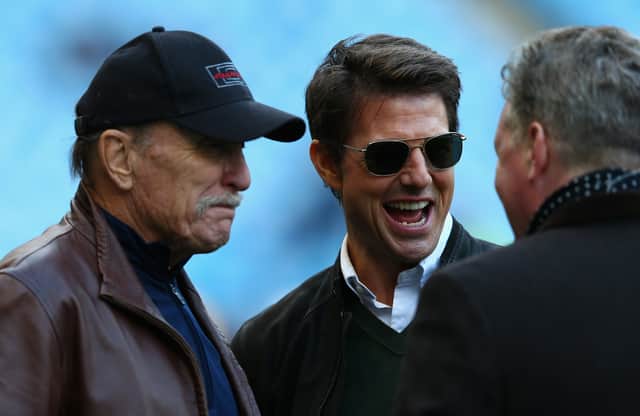 Actors Robert Duvall and Tom Cruise chat to a journalist before a Premier League match between Manchester City and Manchester United at the Etihad Stadium in 2012 (Photo by Clive Mason/Getty Images)