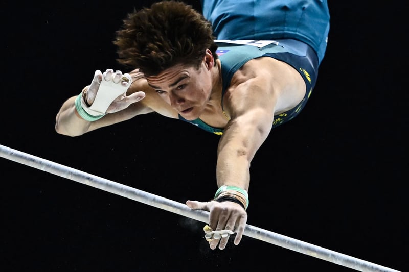 Australia’s Tyson Bull competes during the Men’s Horizontal Bar. (Photo by BEN STANSALL/AFP via Getty Images)