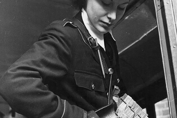 English journalist Anne Scott-James (1913 - 2009) on her first day’s training as a bus conductress for the Midland Red bus company in Birmingham, November 1941. Scott-James is the Women’s editor of Picture Post magazine and is investigating opportunities for women war workers. (Photo by Bert Hardy/Picture Post/Hulton Archive/Getty Images)
