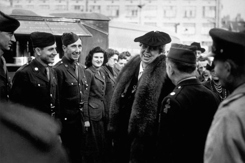 Eleanor Roosevelt, wife of American President Franklin Delano Roosevelt, seen here talking to US soldiers during a visit to a Fighter Factory in Birmingham, during her tour of Britain.