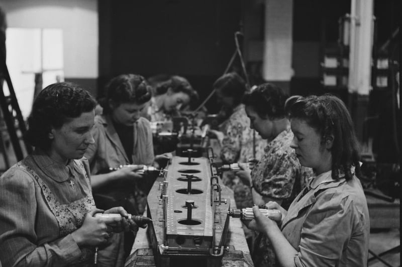  Women working in a factory in Birmingham, England, during World War II, August 1941. From a Ministry of Information special on Birmingham. (Photo by Fred Ramage/Keystone Features/Hulton Archive/Getty Images)