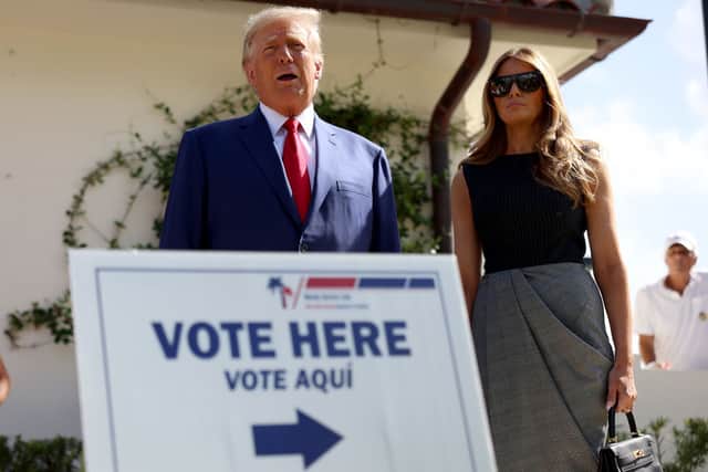 Former U.S. President Donald Trump stands with former first lady Melania Trump as he speaks to the media after voting at a polling station setup in the Morton and Barbara Mandel Recreation Center on November 08, 2022 in Palm Beach, Florida. Credit: Joe Raedle/Getty Images