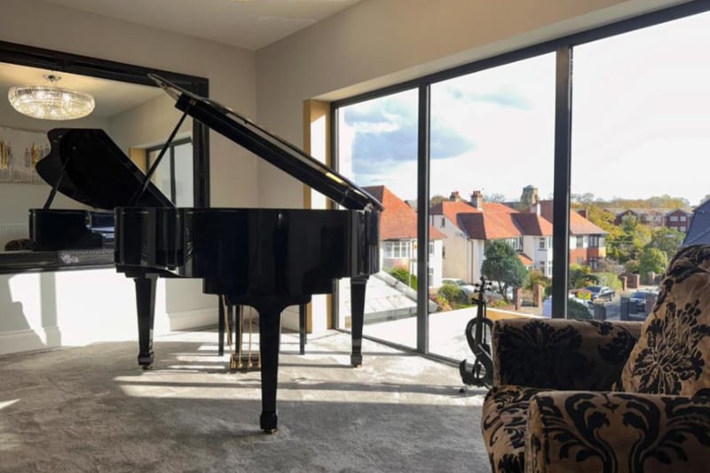 The hallway upstairs features a  large window with views of Victoria Park and enough space for a piano!
