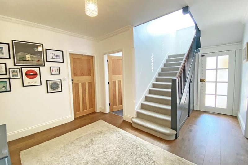 Upon entering the home you are greeted with a large hallway, filled with natural light.