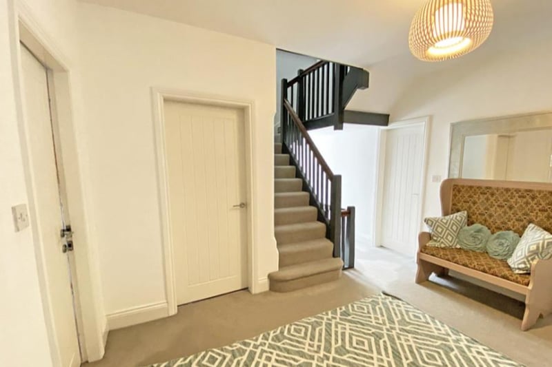 The hall leads to multiple large reception rooms, a breakfast room and kitchen/living area.