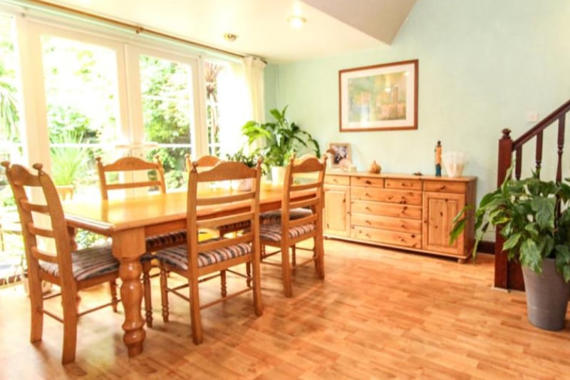 The large kitchen has lovely wood floors and tons of natural light.