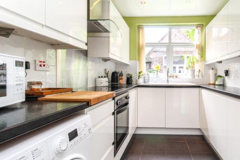 The kitchen features fitted appliances and modern cabinets.