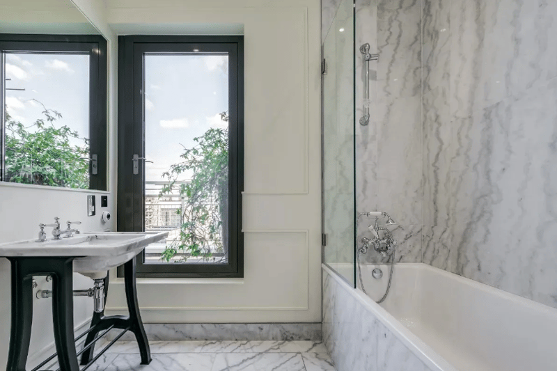 The bath can be used as a shower on beautiful marble flooring