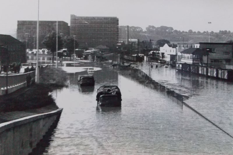 Cars are abandoned along Winterstoke Road. A series of photographs documenting South Bristol during the 1968 flood were presented to Know Your Place during an event held at Ashton Vale Primary School in 2016.
