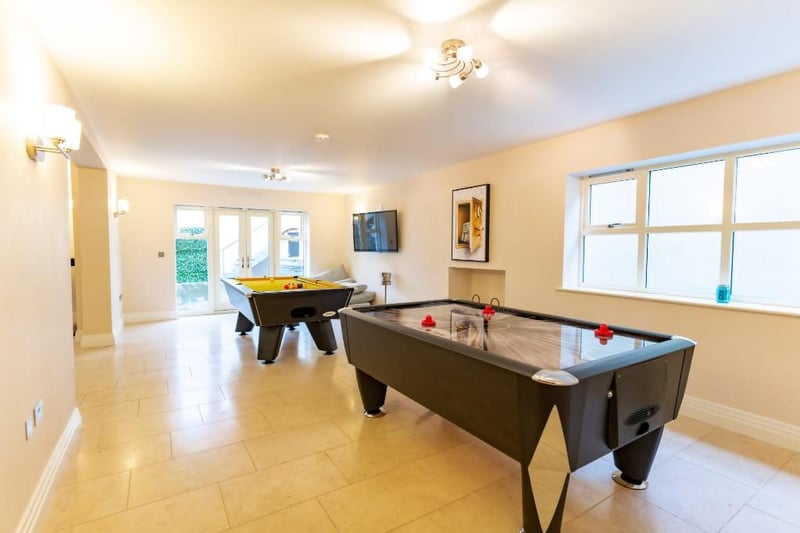 In one room there is an ice hockey and pool table.