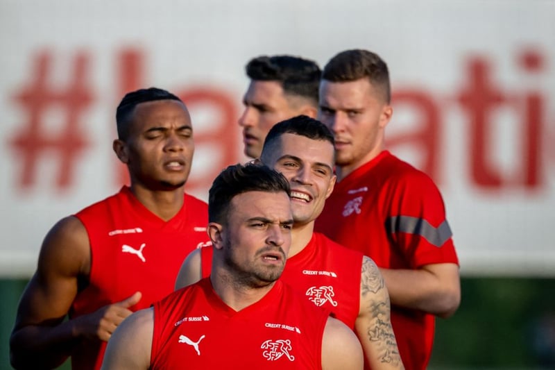 (From L to R) Switzerland’s defender Manuel Akanji, midfielder Xherdan Shaqiri, midfielder Granit Xhaka, defender Fabian Schaer and defender Nico Elvedi warm up during a training session at the University of Doha for Science and Technology training facilities in Doha on November 15, 2022, ahead of the Qatar 2022 World Cup football tournament. (Photo by FABRICE COFFRINI / AFP) (Photo by FABRICE COFFRINI/AFP via Getty Images)
