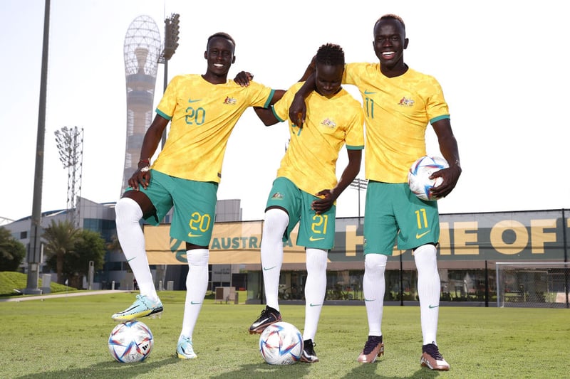 Thomas Deng, Garang Kuol and Awer Mabil of Australia pose during the Australia Official Team Photo at  Aspire Training Ground on November 18, 2022 in Doha, Qatar. (Photo by Robert Cianflone/Getty Images)