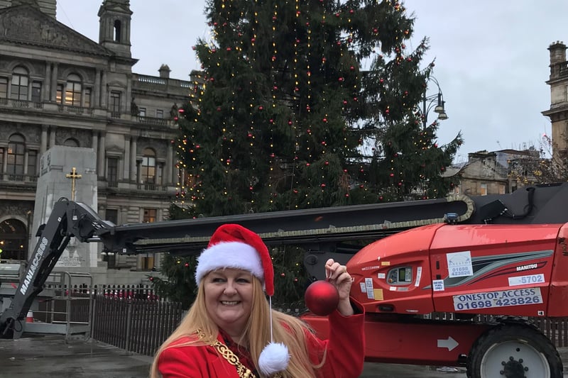 Lord Provost of Glasgow, Jacqueline McLaren, hold the final bauble to place on the George Square Christmas Tree
