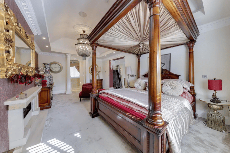 Another bedroom inside the Woodhouses property with a four-poster bed.