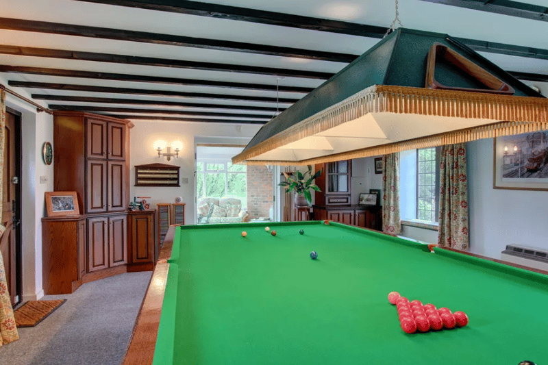 A games room with pool table inside the property