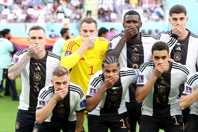 Germany players pose with their hands covering their mouths (Getty Images)