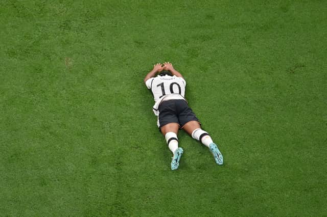 Germany’s Serge Gnabry lies flat on the ground during the shock defeat to Japan (Getty Images)