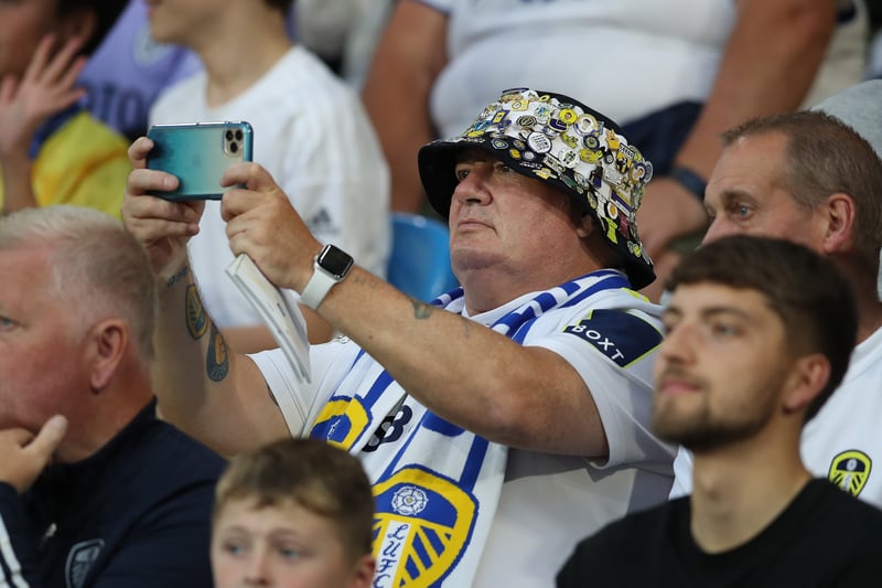 A fan of Leeds United takes a photo of play during the Pre-Season friendly match between Leeds United and Cagliari at Elland Road on July 31, 2022.