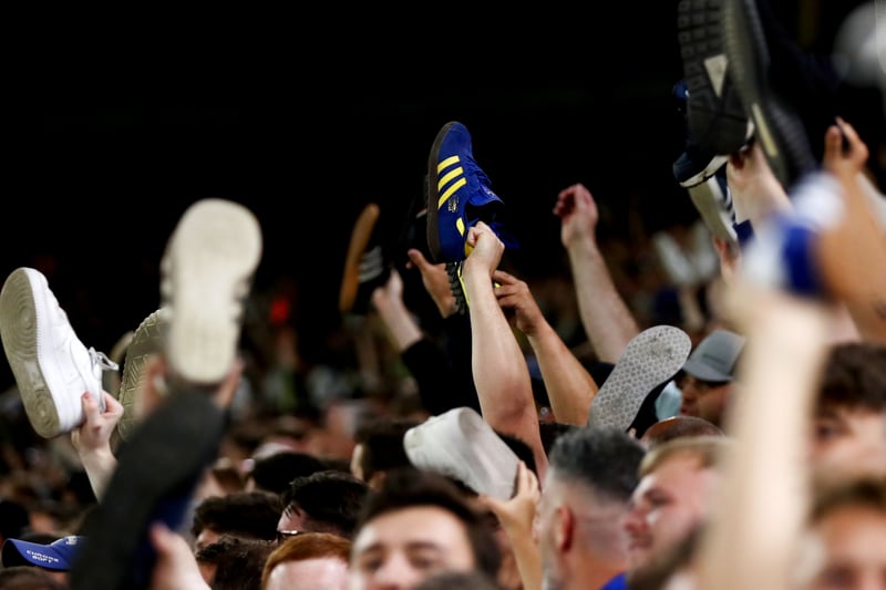 Leeds United fans show their support by taking their shoes off during the Carabao Cup Second Round match between Leeds United and Barnsley at Elland Road on August 24, 2022.