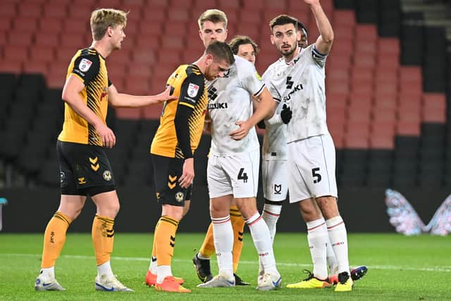 Jack Tucker and Warren O’Hora were the centre-backs against Newport County on Tuesday night, but for the majority of this season, Dons have opted for a back three