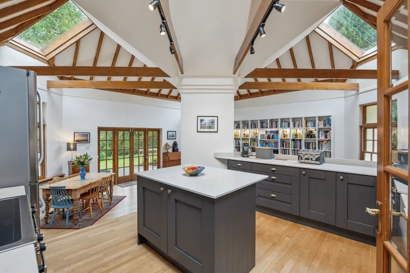 Through the front door and into the open plan kitchen and living space bought to life by the stylish wooden beams and sun roofs.