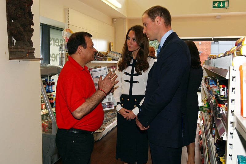 Prince William (R) and his wife Catherine meet Ajay Bhatia (L) at the Machan Express Coffee bar in the centre of Birmingham on August 19, 2011, which was ransacked during the riots in the area. (Photo credit - DAVID JONES/AFP via Getty Images)