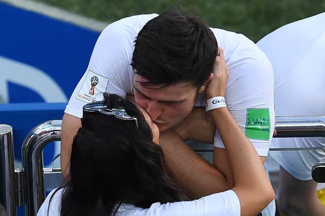 England’s defender Harry Maguire kisses his girlfriend Fern Hawkins after the Russia 2018 World Cup Group G football match between England and Panama at the Nizhny Novgorod Stadium in Nizhny Novgorod on June 24, 2018.  (Credit JOHANNES EISELE/AFP via Getty Images)
