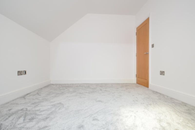 The bedroom has a soft grey carpet and is finished to a high standard.