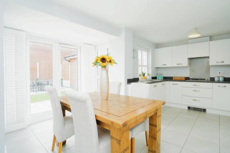 The kitchen/dining area is finished to a high standard with white cupboards and fitted appliances.