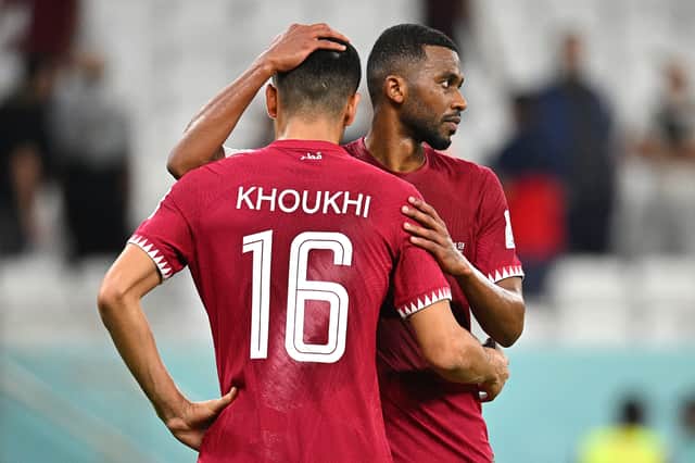 Qatar players show dejection after their 1-3 defeat (Getty Images)