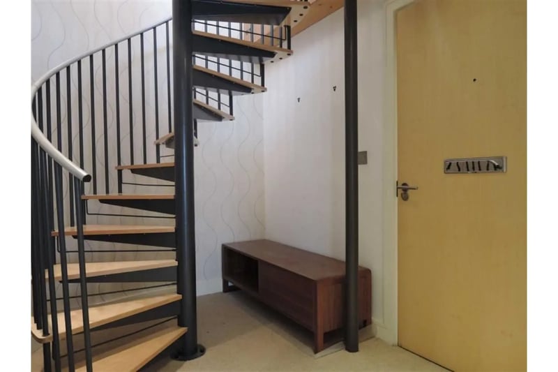 The iron spiral staircase as you walk into the apartment is a stunning feature leading to the mezzanine level