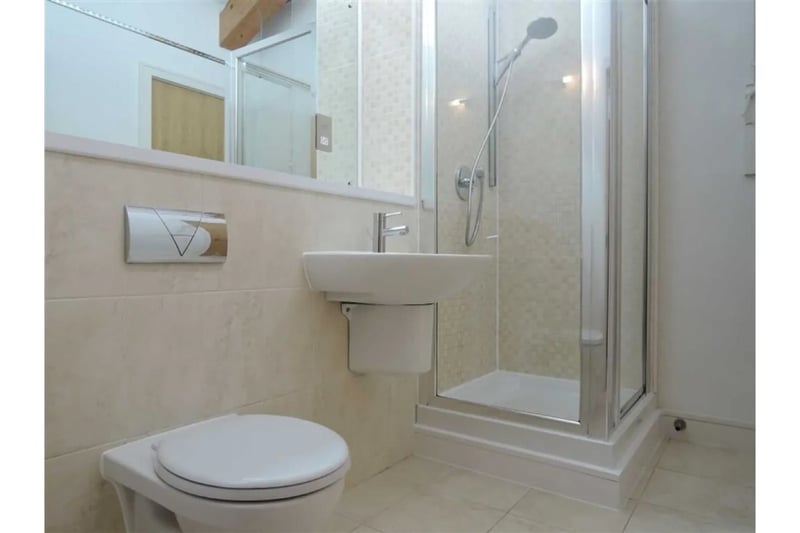 The bathroom has been furnished to a modern standard with a clean aesthetic opposed to the brickwork throughout the property