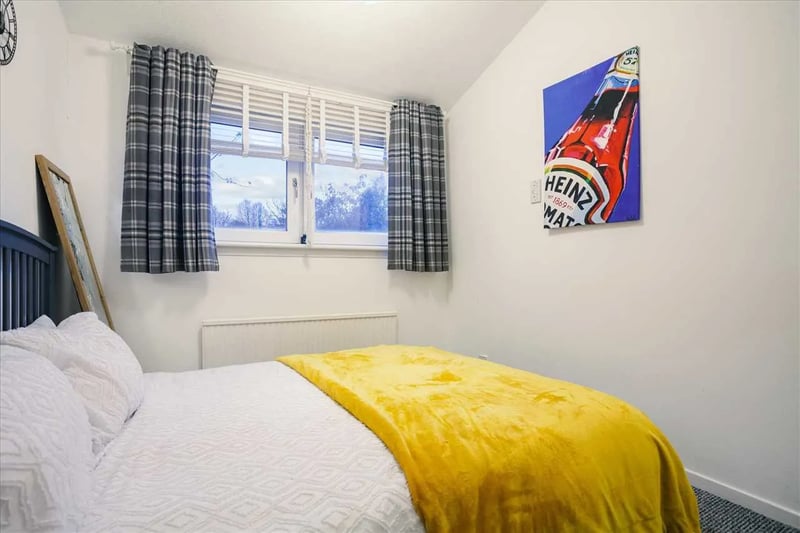 The first double bedroom of the upper level is a spacious and cosy