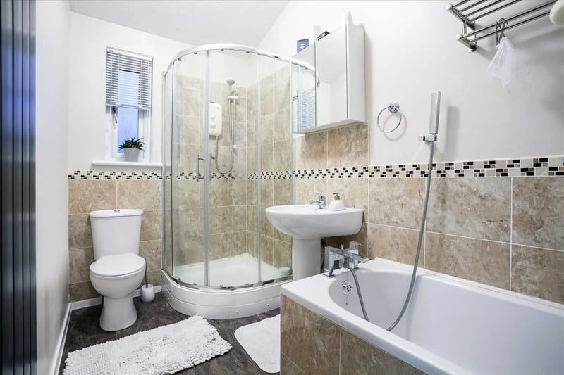 An upgraded four piece bathroom consisting of a separate walk in shower cubical and bath suite finished with a wall tiling and vinyl flooring