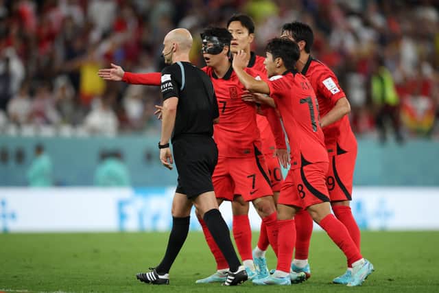 Son Heung-min and team-mates argue a call with referee Anthony Taylor (Getty Images)