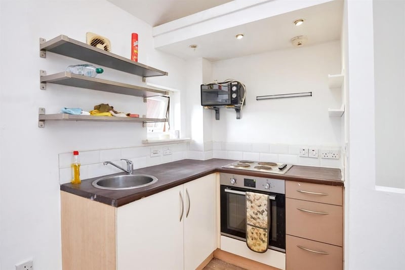 The flat’s kitchen area features an inbuilt oven and hobs. 