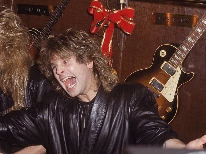 Ozzy Osbourne screams inside a bar, with an electric guitar mounted on the wall behind him, 1980s. (Photo by Hulton Archive/Getty Images)
