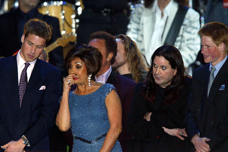 Prince William (L) talks with Dame Shirley Bassey (2nd L) as Ozzy Osbourne (2nd R) stands with Prince Harry (R) on stage at the finale of “Party at the Palace” in London 03 June 2002. As part of Queen Elizabeth’s Golden Jubilee celebrations 12,000 people watched a pop concert featuring singers spanning many generations in the garden of Buckingham Palace to celebrate Queen Elizabeth’s 50 years on the throne. (Photo - ADRIAN DENNIS/AFP via Getty Images)