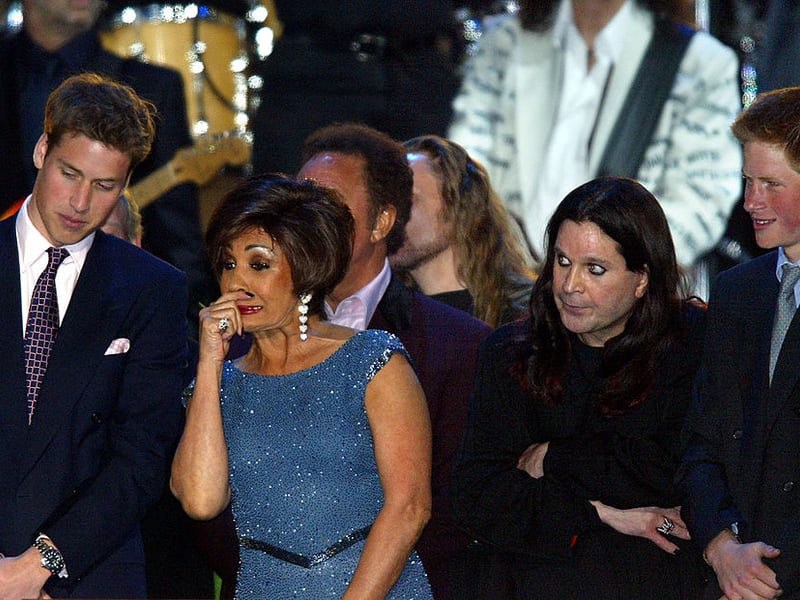 Prince William (L) talks with Dame Shirley Bassey (2nd L) as Ozzy Osbourne (2nd R) stands with Prince Harry (R) on stage at the finale of “Party at the Palace” in London 03 June 2002. As part of Queen Elizabeth’s Golden Jubilee celebrations 12,000 people watched a pop concert featuring singers spanning many generations in the garden of Buckingham Palace to celebrate Queen Elizabeth’s 50 years on the throne. (Photo - ADRIAN DENNIS/AFP via Getty Images)