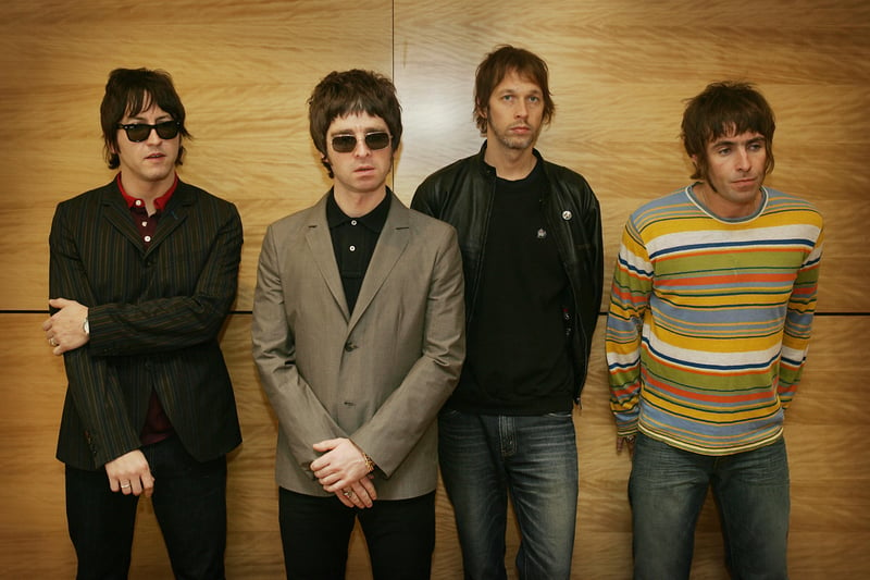 Gem Archer, Noel Gallagher, Andy Bell and Liam Gallagher pose for a photo in Hong Kong. Credit: Getty