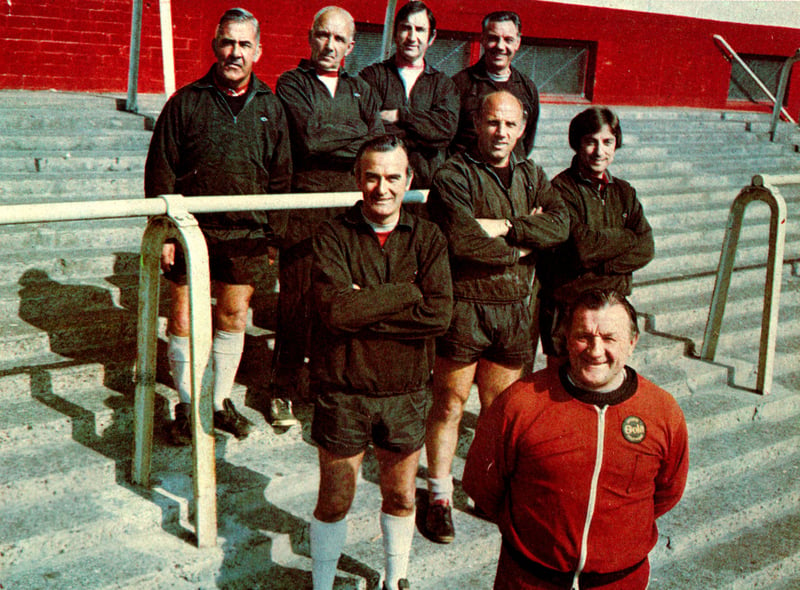 Liverpool manager Bob Paisley and the Boot Room boys pose on the steps of the old Kop. (Photo by Liverpool FC via Getty Images)