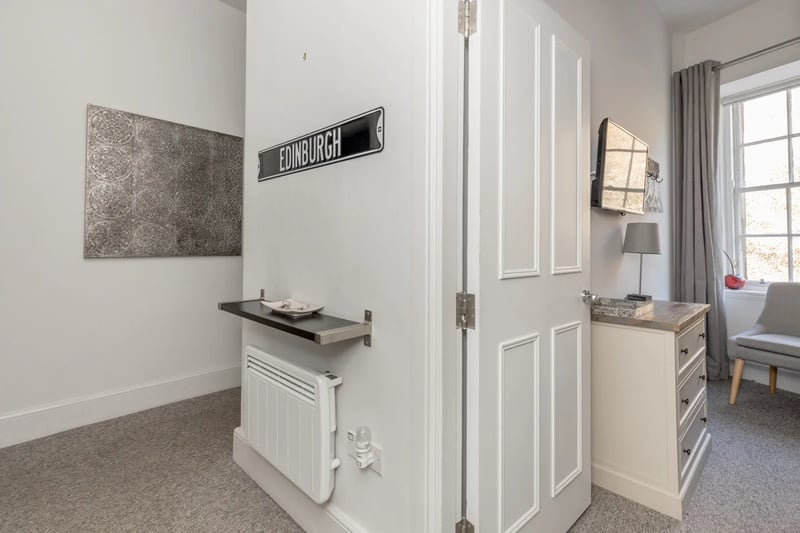Through the entrance to the ground floor flat and into the reception area which features a separate utility room