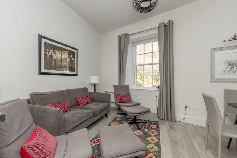 The spacious living space is boosted by curtains and light fittings which come with the property 